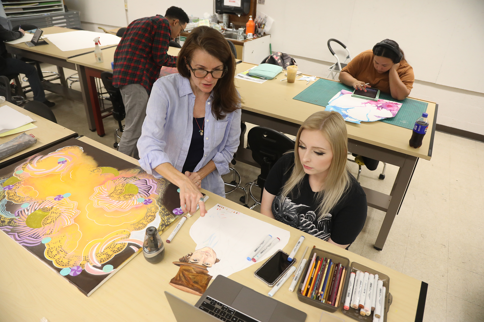 Art students in class with UNCP faculty member