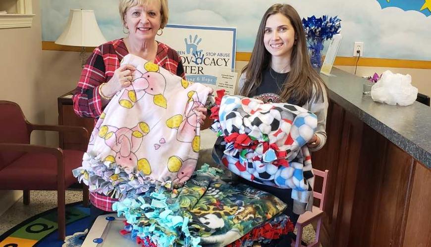  Psi Chi students volunteering to make blankets for the Child Advocacy Center in Fayetteville. We donated 10 blankets and had a lot of fun making them! :-) 
