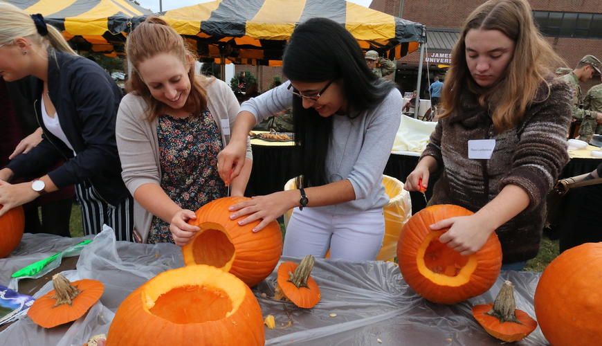 image of students carving pumpkins