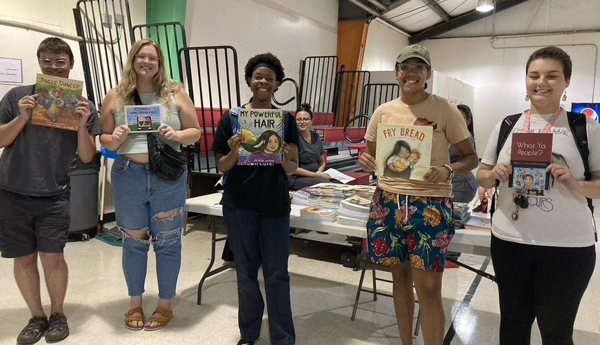 Sigma Tau Delta students read Native American children's books during Literacy Night for Hoke County schools. 