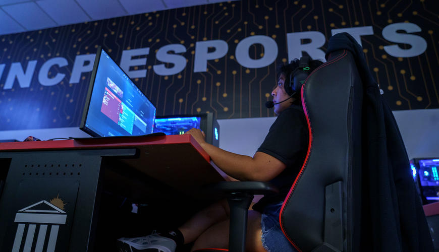 A student sitting in a plush gaming chair.