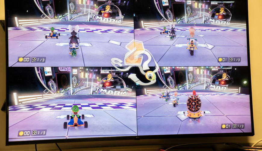 A four player split screen match of Mario Kart.