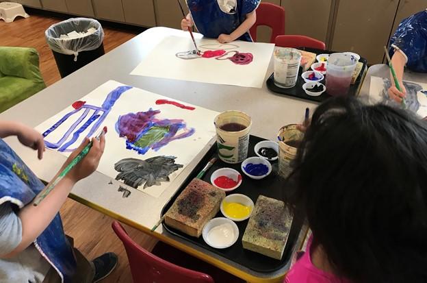 Art Education Student Teacher facilitating a painting experience with kindergarteners. 