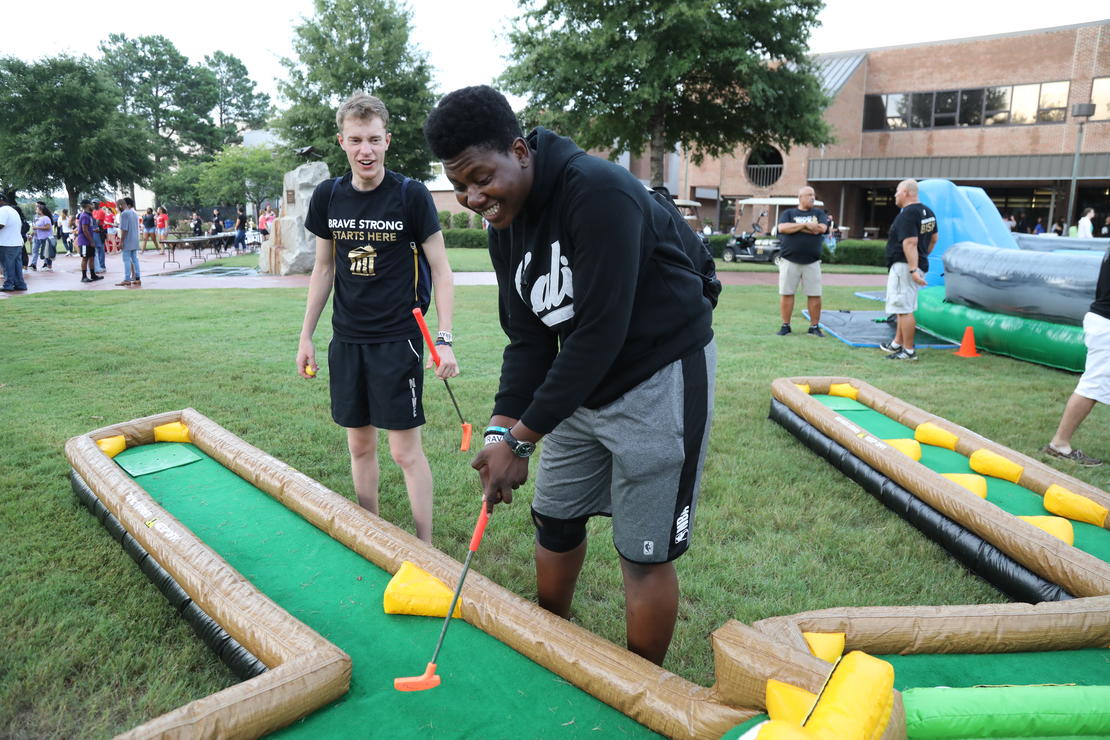 students playing putt putt at Brave Nation Bash