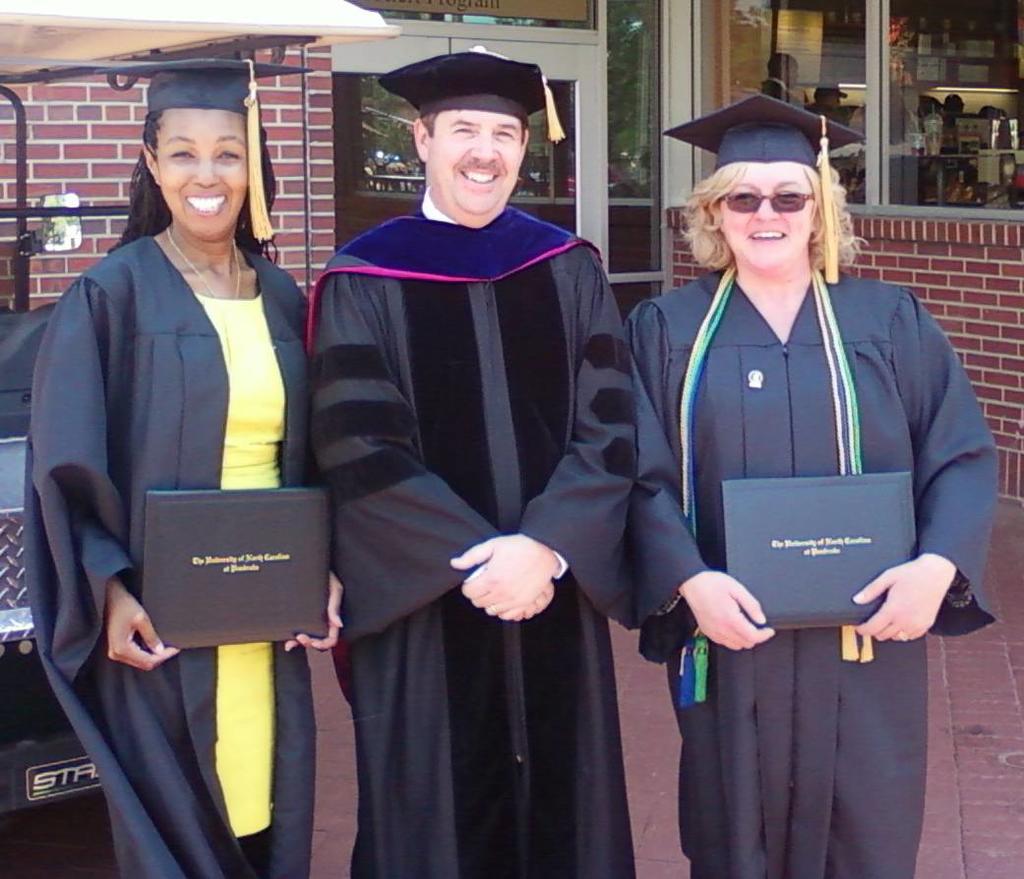 BIS May 2014 Graduates Nancia Smith (on the left) and Lori Smith (on the right) with Provost Kitts (center)