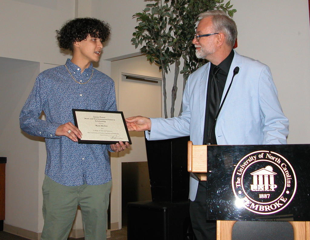 Ryan McGirt receiving the James Porter Math and Environmental Science Scholarship from Dr. Richard Gay