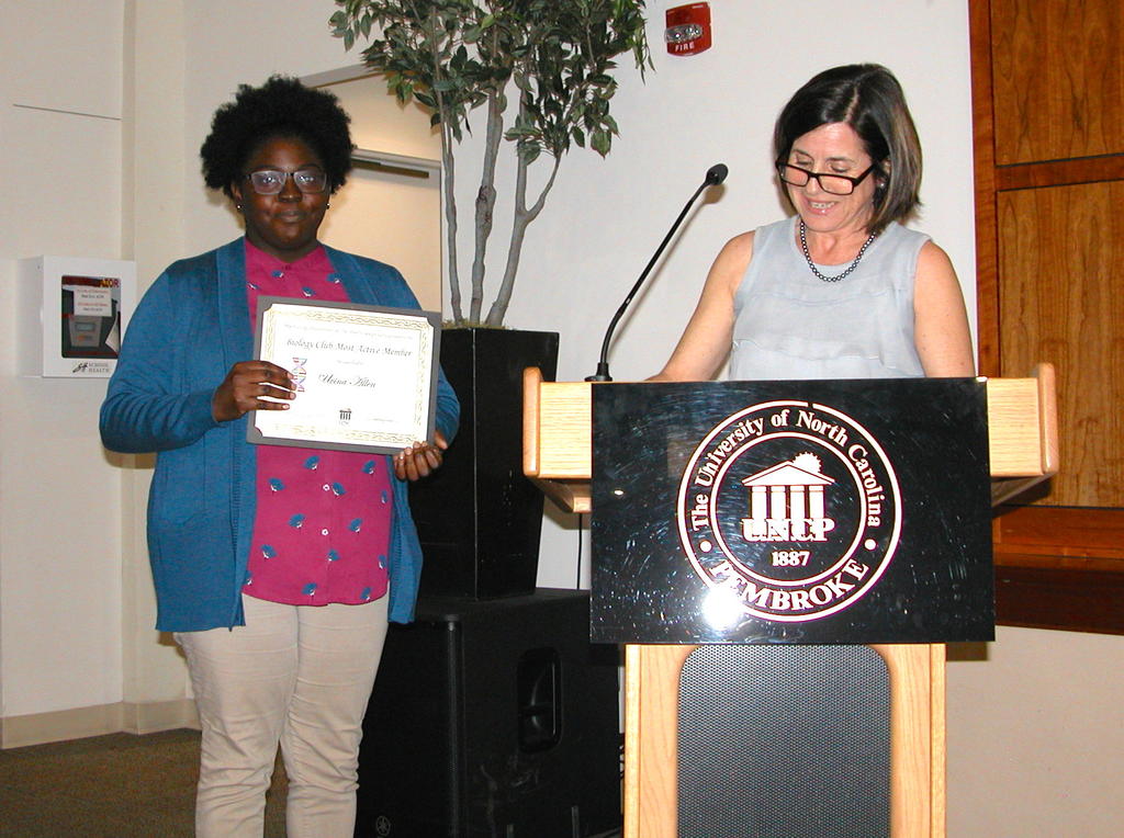 Uvina Allen receiving the Biology Club Award from Dr. Maria Santisteban