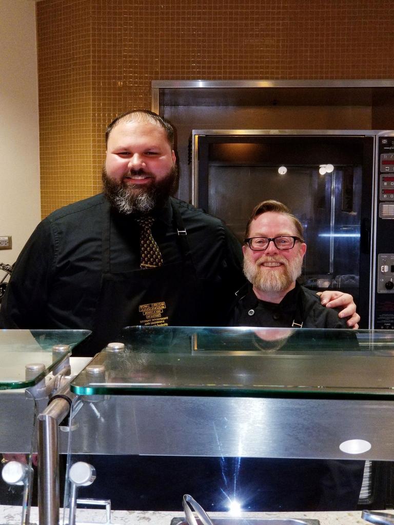 Adjunct Professor Rudy Locklear (L) and Dr. J. Porter Lillis help with serving students during the spring 2018 late night exam breakfast.