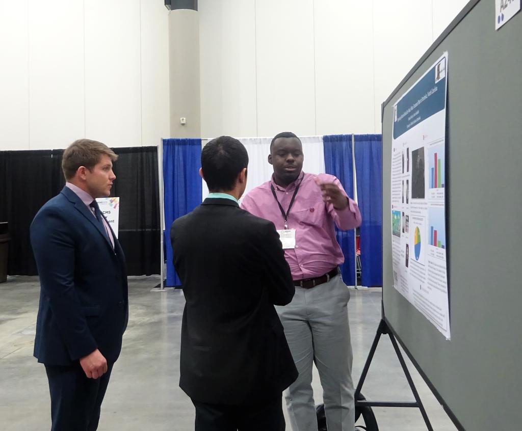 Dontae Mosley presenting his poster at ABRCMS to an audience of two.