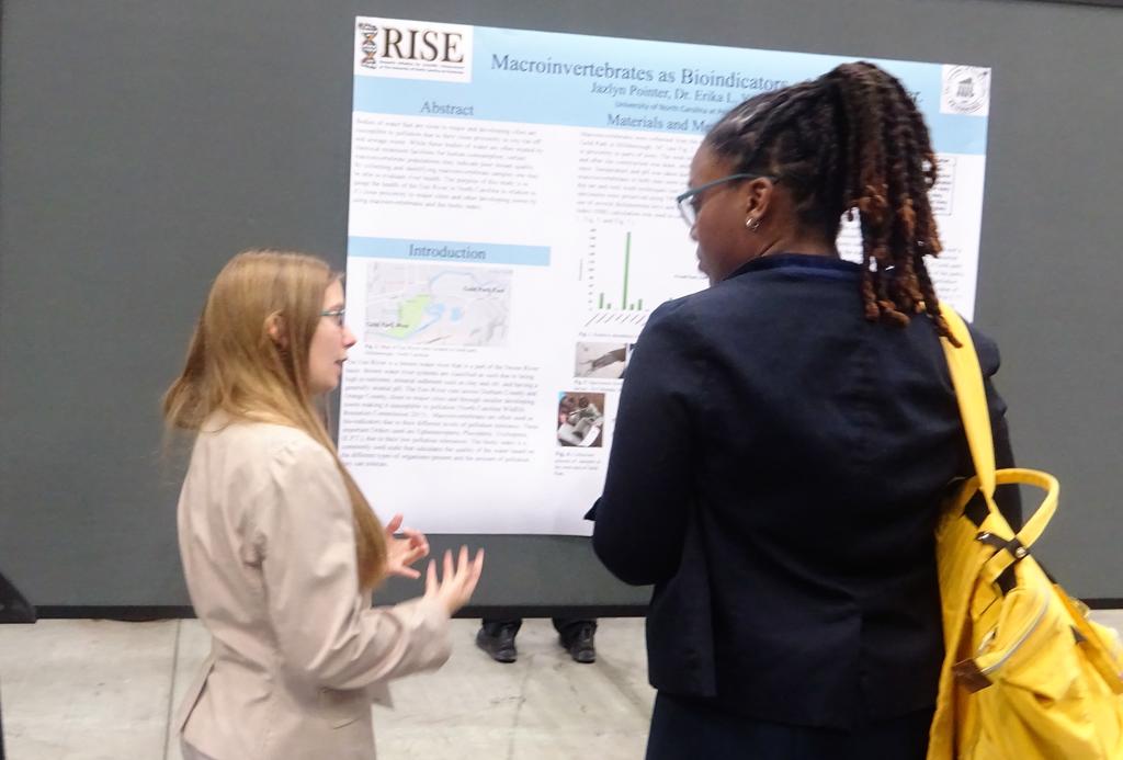 Jazlyn Pointer discussing her research with a judge.