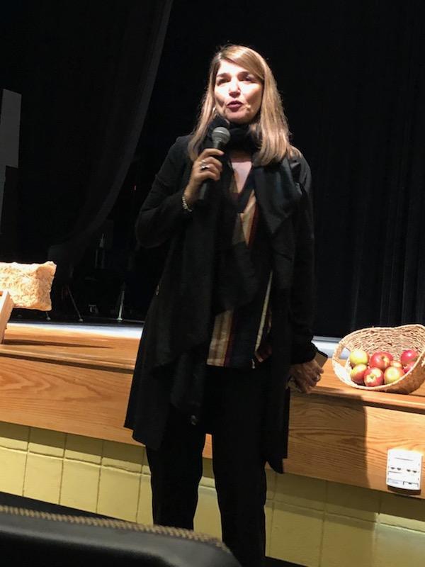 Dr. Ana Cecilia Lara speaks before an audience at Clinton High School before Acto Latino performs La Quinta Temporada on November 8, 2018.