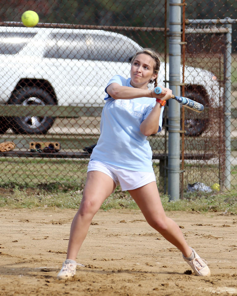 Woman hitting a softball