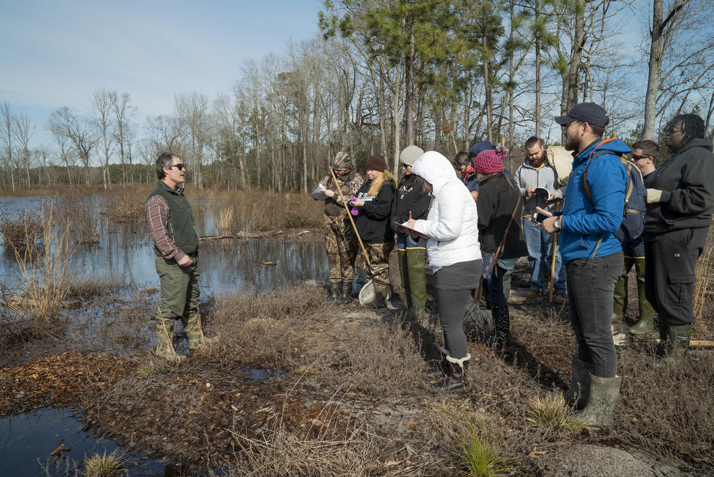 Dr. Roe with students conducting fieldwork