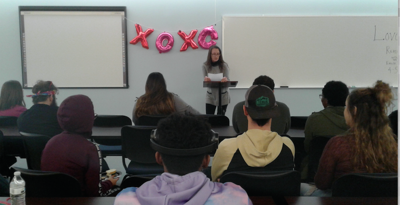 Dr. Cyndi Miecznikowski reads a poem at the Love/Hate Mic event on Feb. 13, 2019.