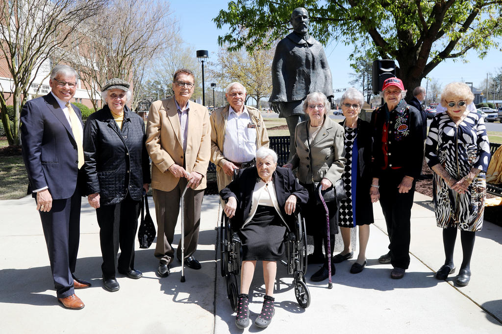 Chancellor Robin Gary Cummings (left), poses in front of the Hamilton McMillan statue with alumni Dorothy Blue, James C. Dial, Josephus Locklear, Cattie Mae Hunt (seated), Josephine Ransom and her twin sister Catherine Locklear, Bernice Brooks Lowry and Doris Hall