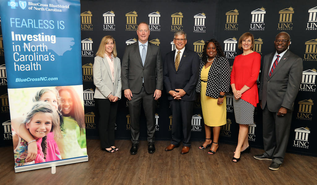 Blue Cross CEO and President Dr. Patrick Conway (second from left), and UNCP Chancellor Dr. Robin Gary Cummings (third from left), join Blue Cross representatives to celebrate the establishment of the Community and Wellness Institute at UNC Pembroke