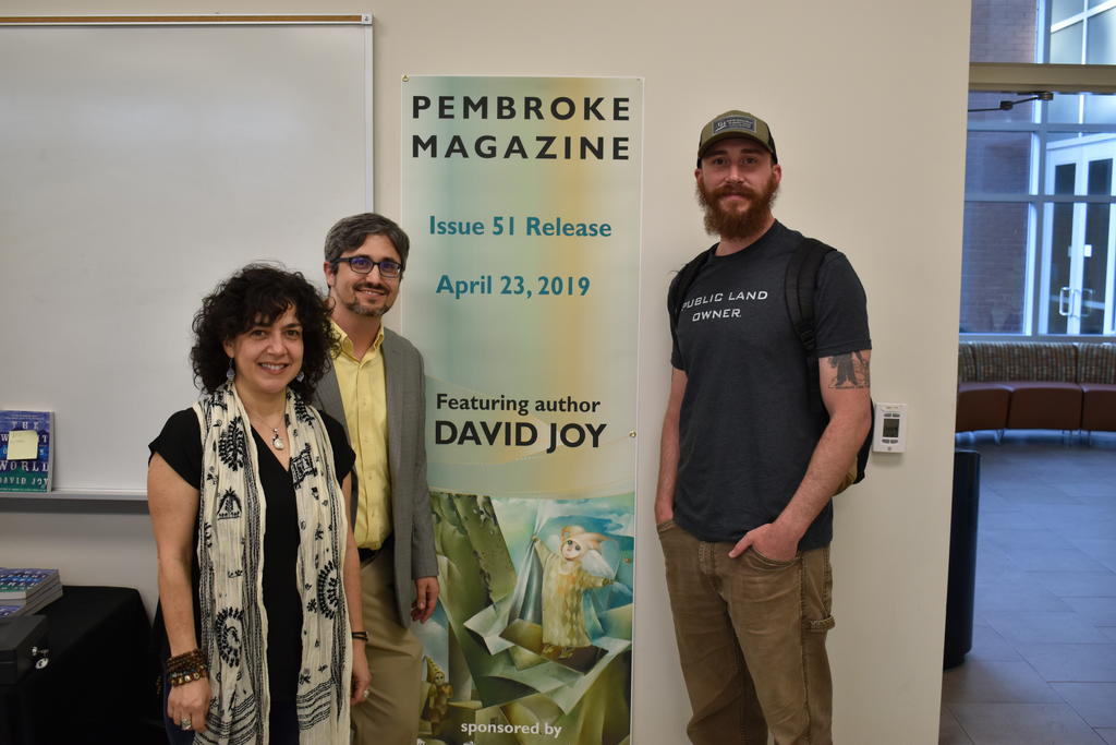 English Department faculty Dr. Michele Fazio (left) and Peter Grimes are shown with best-selling author David Joy during the Pembroke Magazine 51st issue release party