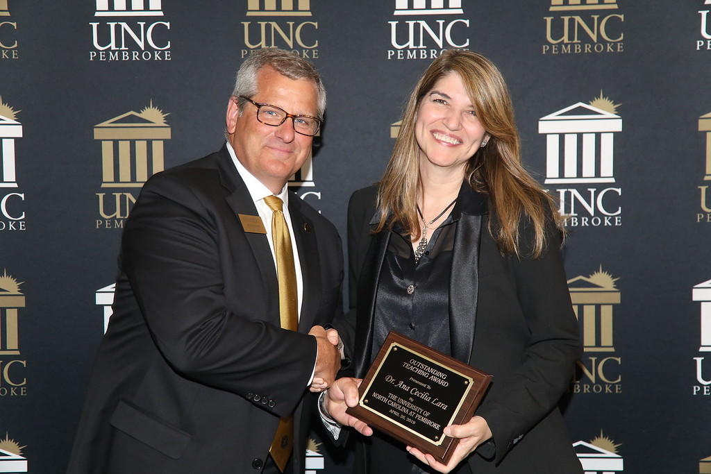Provost Dr. David Ward congratulates Dr. Ana Cecilia Lara for earning the Outstanding Teacher Award at the 2019 Faculty Appreciation Dinner.