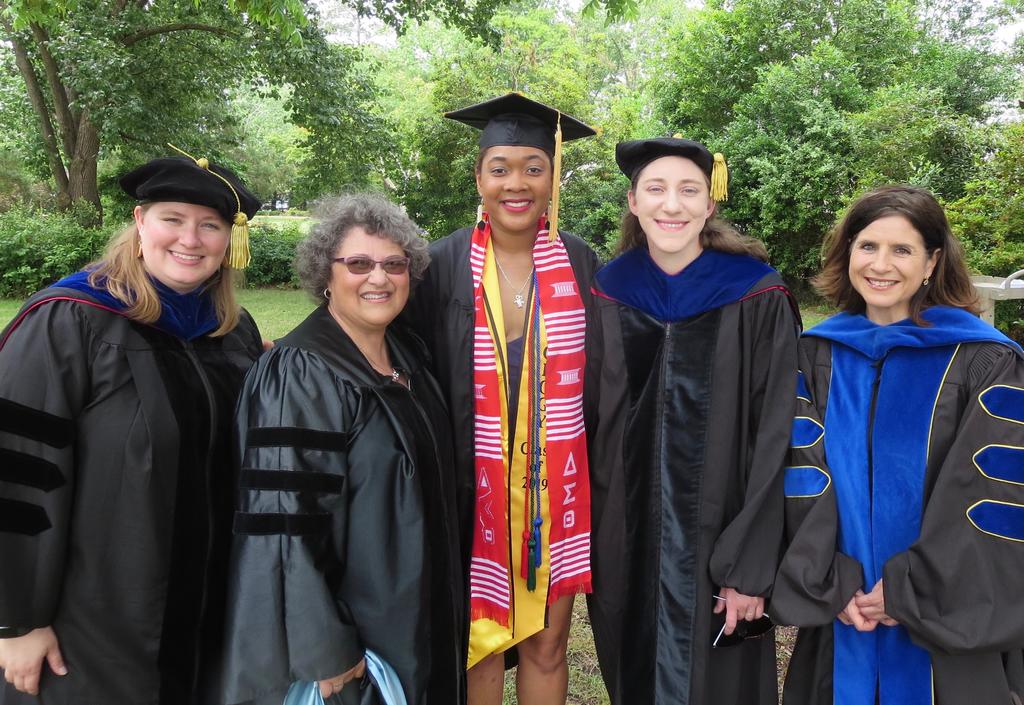 Courtney Moore (center) and Drs. Amber Rock, Velinda Woriax, Kaitlin Campbell, and Maria Santisteban