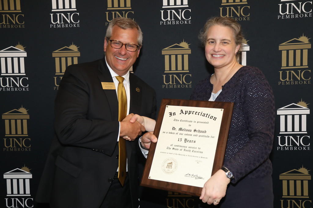 Provost Dr. David Ward congratulates Dr. Melissa Schaub for 15 years of service at the 2019 Faculty Appreciation Dinner.
