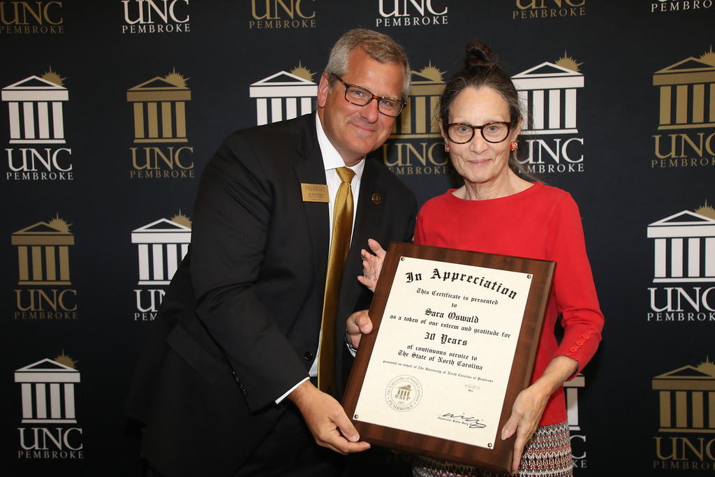 Provost Dr. David Ward congratulates Professor Sara Oswald for 30 years of service at the 2019 Faculty Appreciation Dinner.