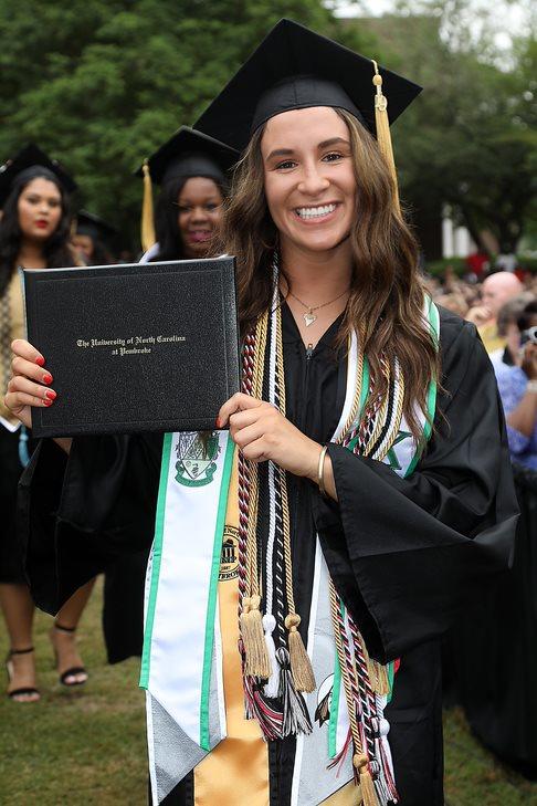 Avery Locklear, a member of the Women's Basketball team, proudly displays her diploma