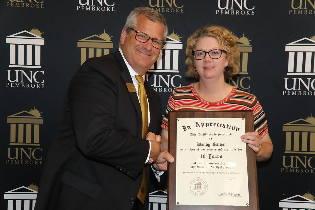 Provost Dr. David Ward congratulates Dr. Wendy Pearce Miller for 10 years of service at the 2019 Faculty Appreciation Dinner.