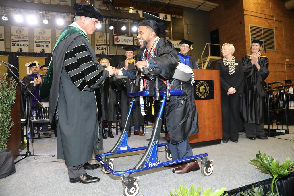 Dustin Chavis shaking Chancellor Cummings hand during Graduation