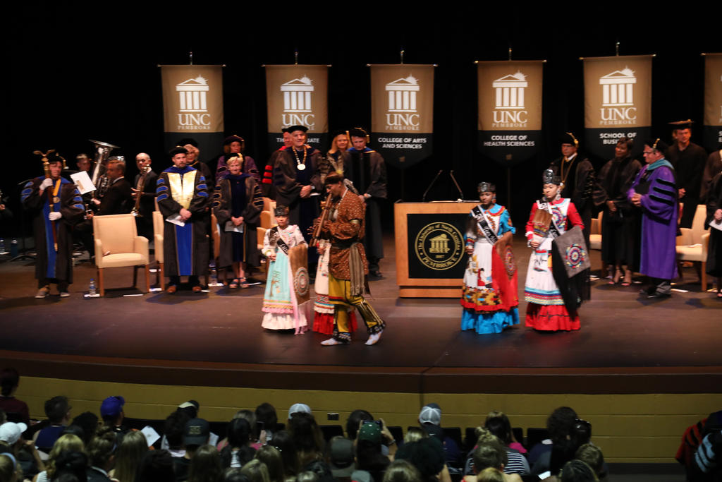 Flutist John Oxendine and the Lumbee Ambassadors lead the recessional at the 2019 First-Year Student Convocation at Givens Performing Arts Center on Aug. 12, 2019