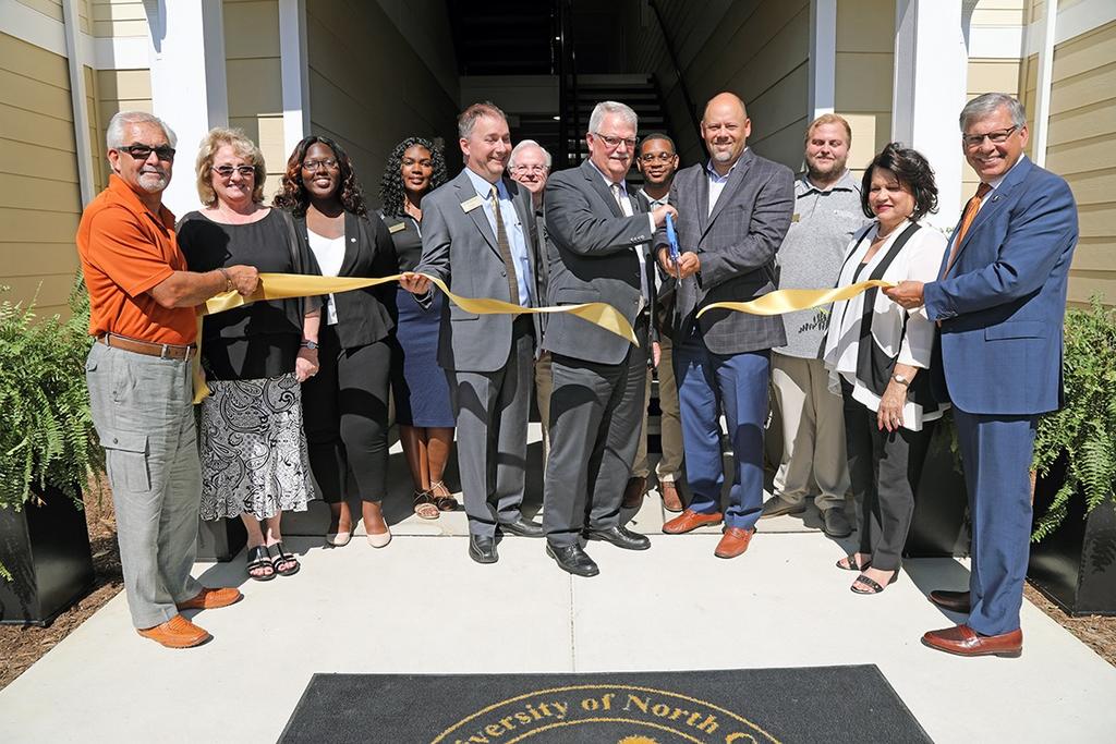Chancellor Robin Gary Cummings (far right) joins university and town officials during a ribbon-cutting ceremony marking the expansion of University Courtyard Apartments
