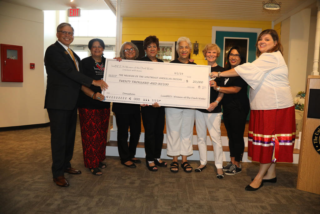 Chancellor Robin Gary Cummings (far left) and Nancy Strickland Fields (far right) accepts a generous $20K gift from the cast of lumBEES: Women of the Dark Water