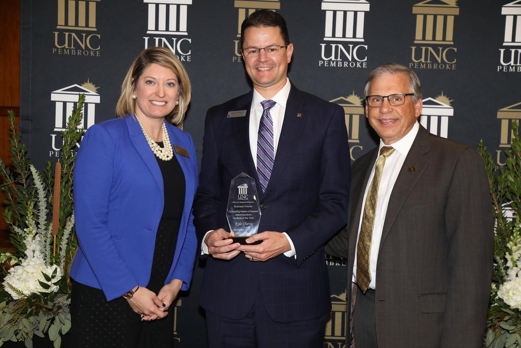 Kyle Chavis was presented with the award for MBA Student of the Year. He is pictured with Christine Bell and Chancellor Cummings