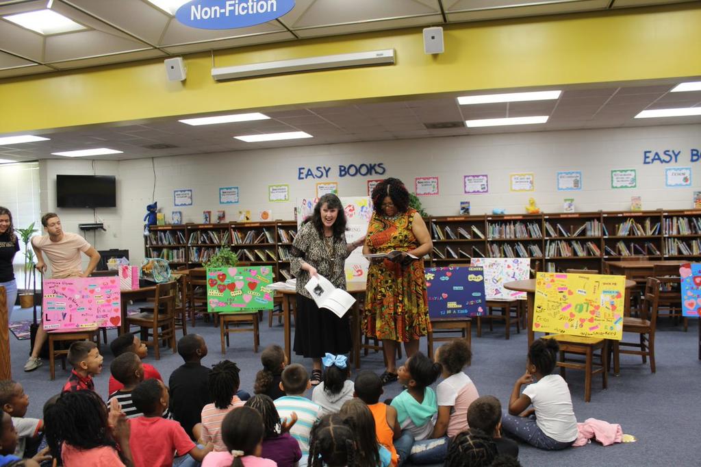 Professor Deana Johnson engages with students at R.B. Dean Elementary School during a reading party.