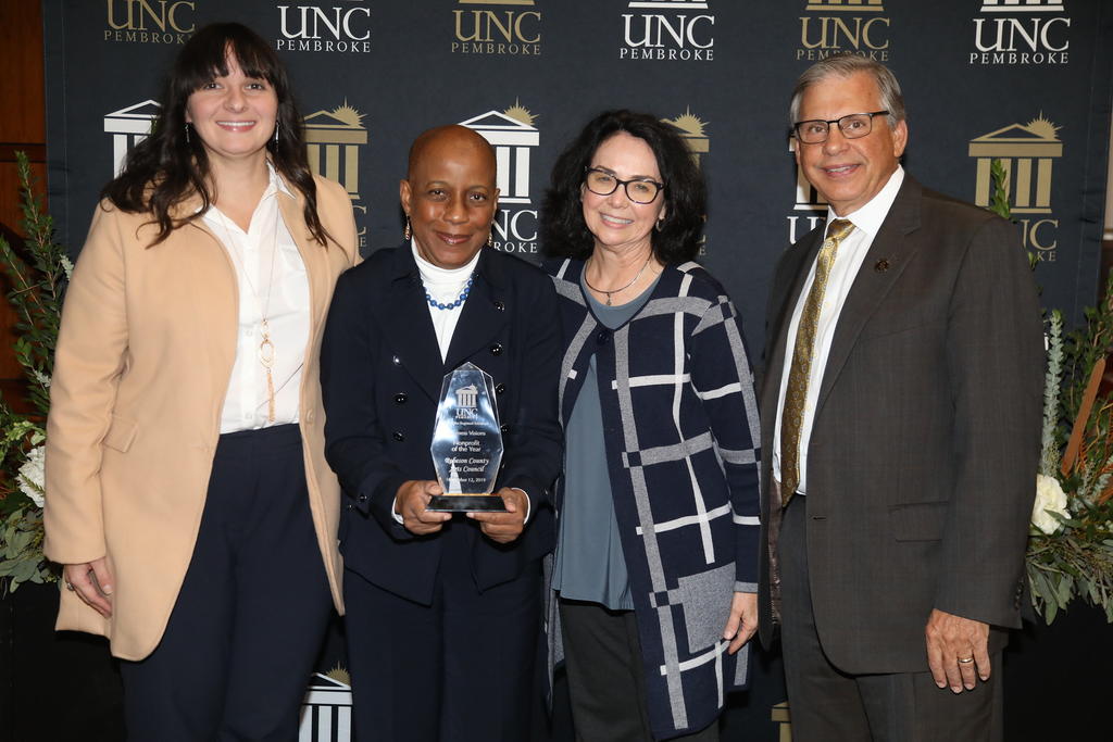 Vanessa Abernathy accepts the Nonprofit of the Year award on behalf of the Robeson County Arts Council. Also pictured are Mary Ann Ann Masters, Brittany Sandefur and Chancellor Cummings