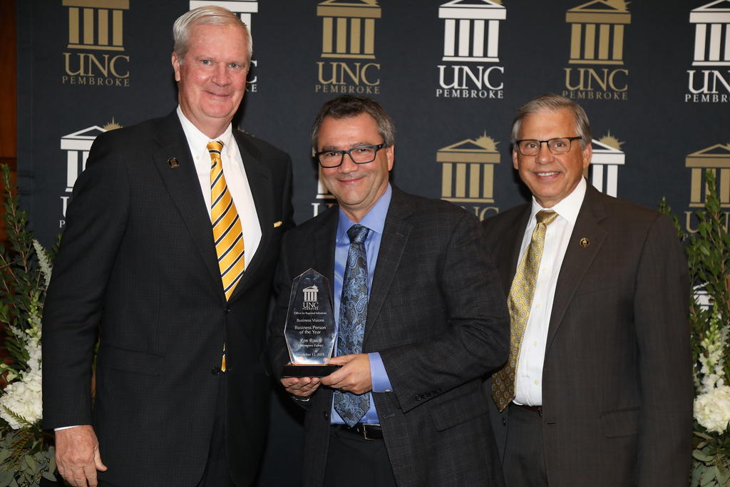 Ron Roach, recipient of the Business Person of the Year award, is pictured with Dan Kenney and Chancellor Cummings