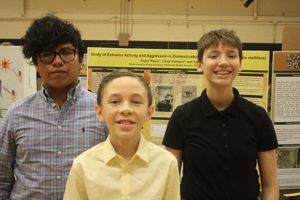 Cesar, Tyler, and Taylor present research poster on honeybee agression