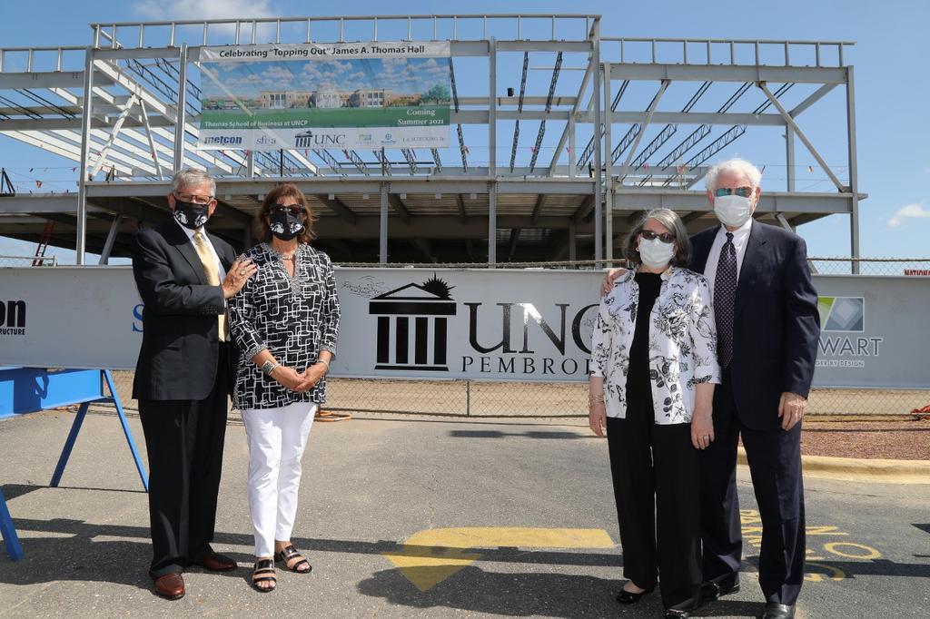 Chancellor Robin Gary Cummings and wife, Rebecca, and Jim Thomas, and wife, Sally, attend the topping out ceremony for the James A. Thomas Hall
