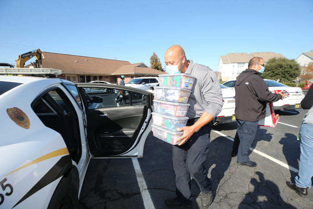 Sgt. Stephen Brooks loads holiday care packages on Friday, December 11, 2020