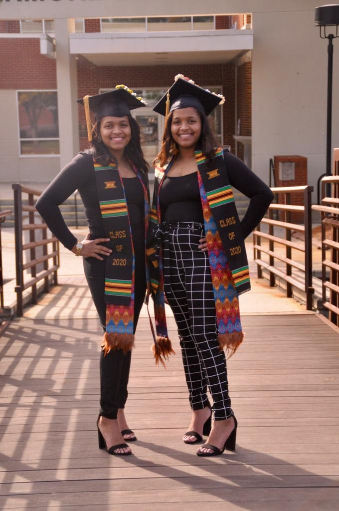 2020 graduates Kelsey and Kyria Locklear pose before Fall Commencement