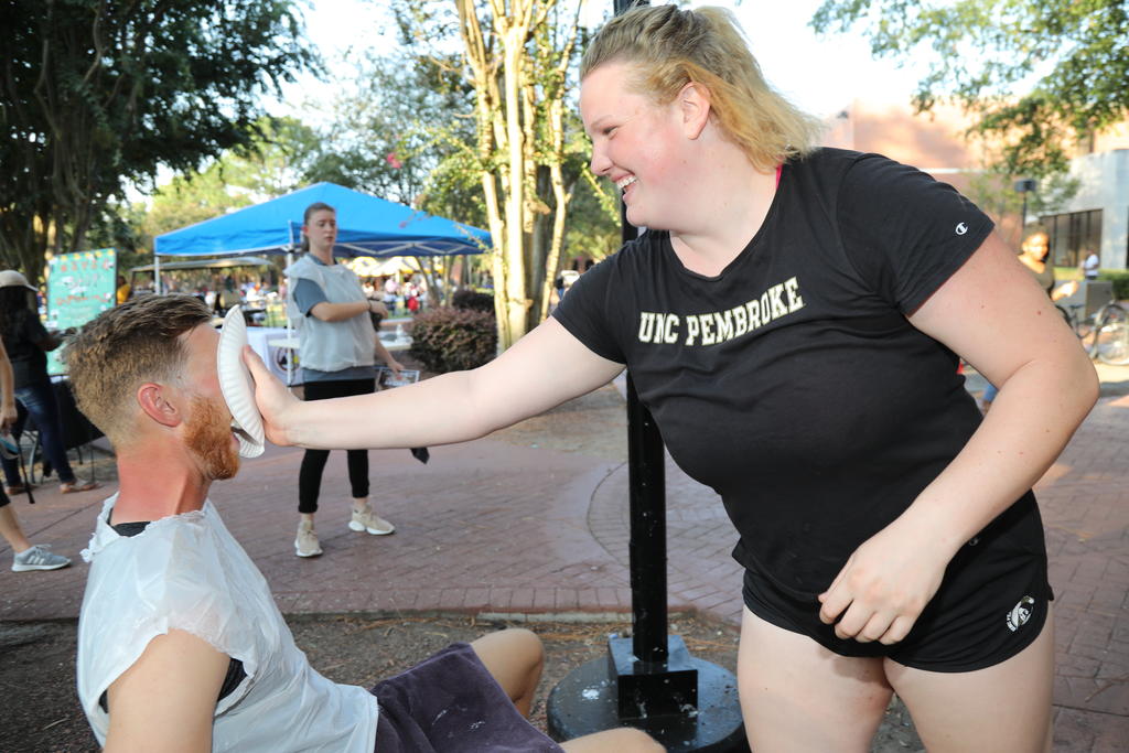 A UNCP student accepts a friendly 'pie in the face challenge' at Pembroke Day