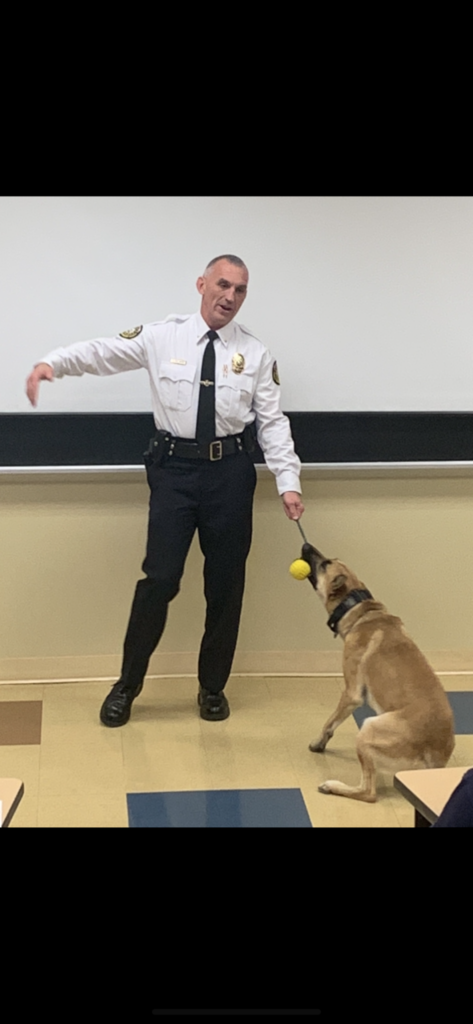 Hope Mills Chief of Police Steve Dollinger visits Mr. Jesse McQueen's criminal justice class with police canine, Kaeden.
