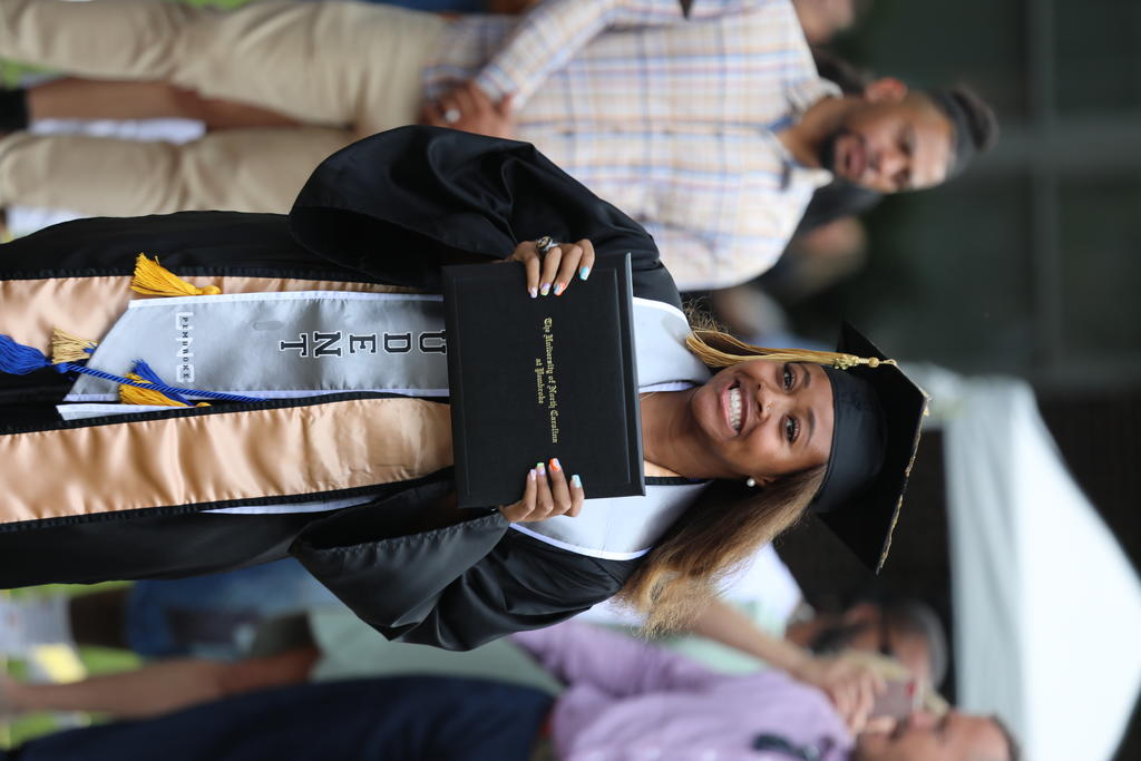 Soccer player Maya Grimes proudly shows off her diploma at Spring Commencement on May 14, 2022