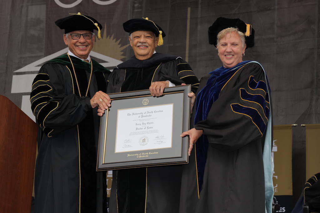 Chancellor Robin Gary Cummings and Interim Provost Zoe Locklear present Larry Chavis (center) an honorary Doctor of Laws degree during Spring Commencement