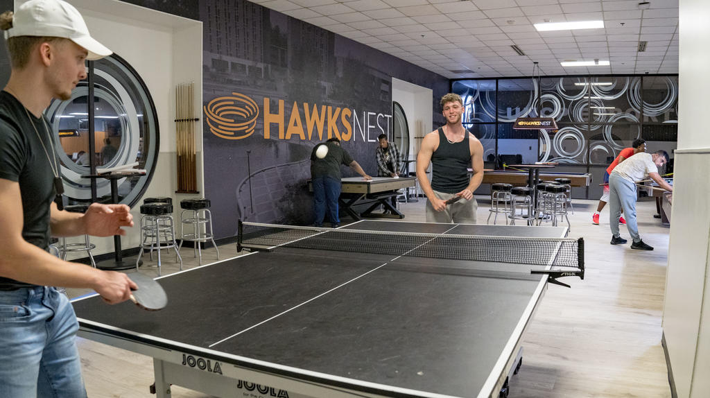 two men playing ping pong in the Hawks Nest