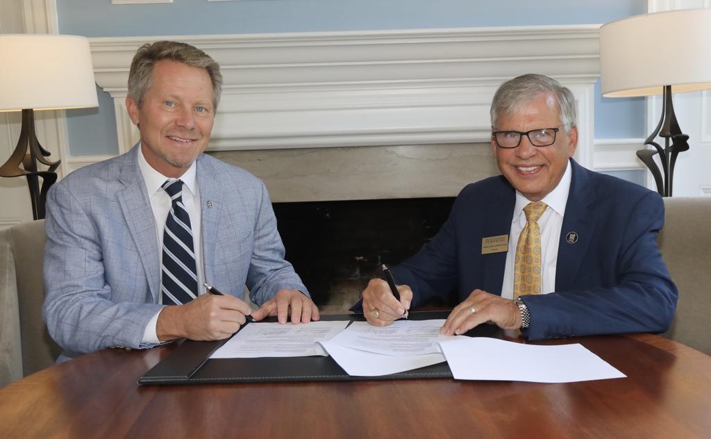 UNC-Chapel Hill Chancellor Kevin M. Guskiewicz (left) sign a MOU agreement with UNCP Chancellor Robin Gary Cummings