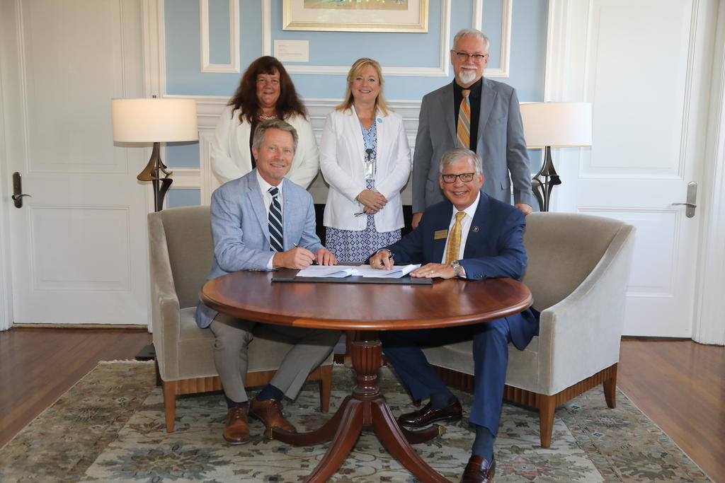 Seated: Chancellor Kevin M. Guskiewicz (left) Chancellor Robin Gary Cummings Standing - Dr. Betsy Sleath, Regional Associate Dean for Eastern North Carolina in the UNC Eshelman School of Pharmacy (left) Dr. Angela Kashuba, dean of Eshelman School of Pharmacy and Dr. Richard Gay, dean of the College of Arts and Sciences for UNCP
