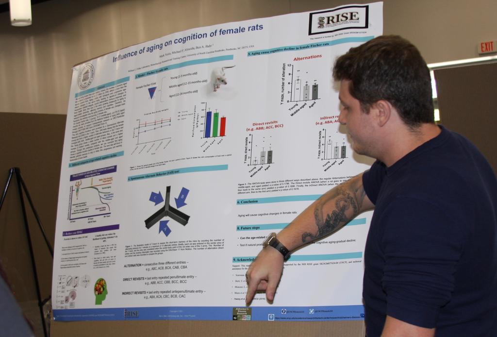 Mark Yorio explains his research poster