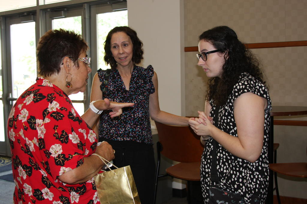 Research presenter Emily Harrison (pictured on the far right) chats with Dr. Maria Pereira