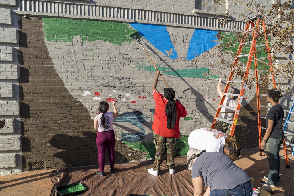 Art mural project students painting.