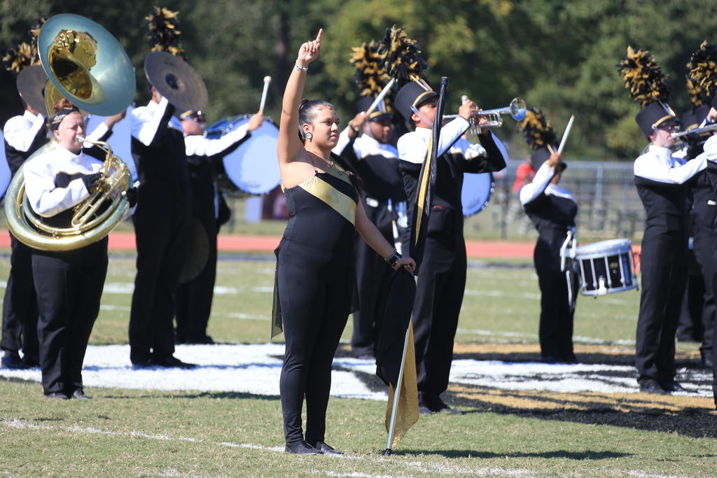 Colorguard member Ashley Arriaga shows the traditional "one finger" during the alma mater